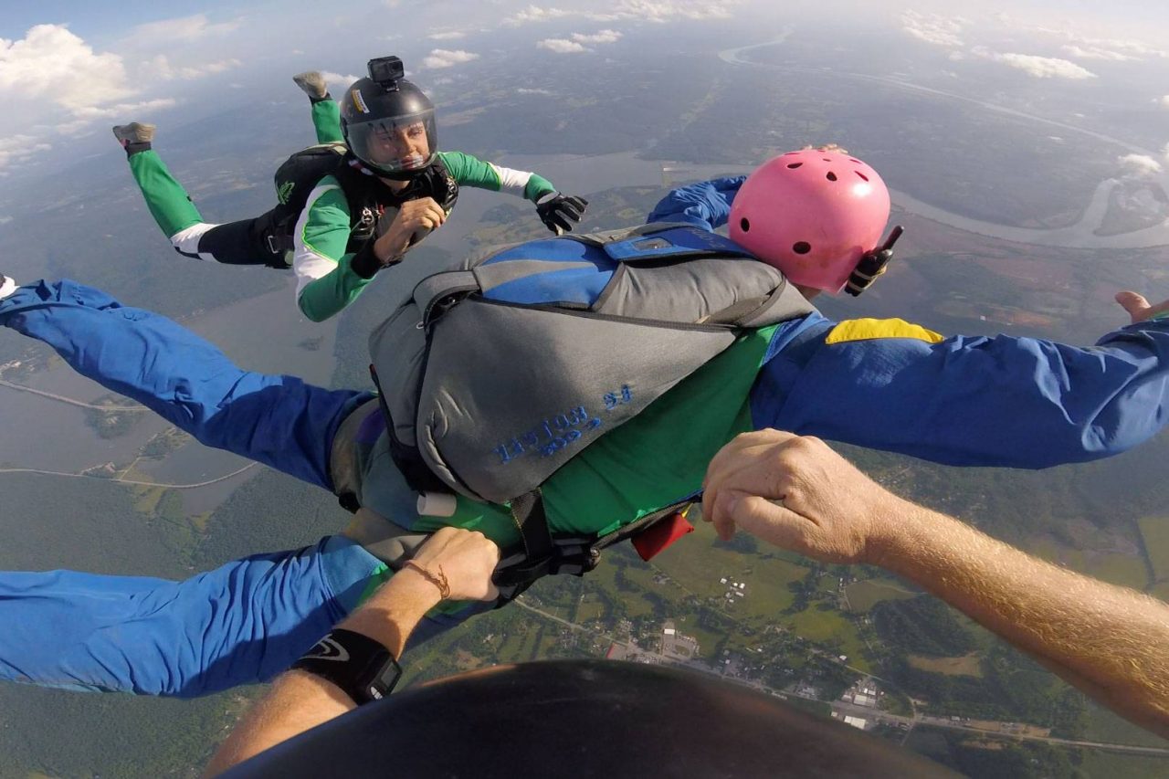 Man wearing pink helmet in freefall during AFF training at Chattanooga Skydiving Company